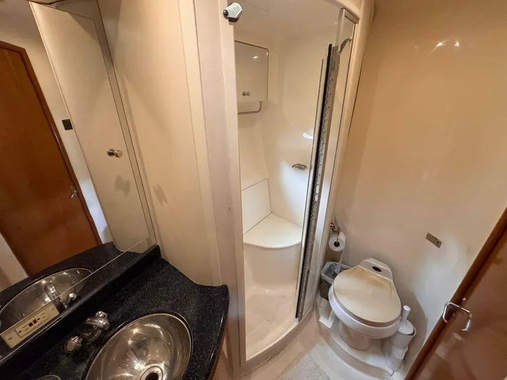  Yacht Photos Pics Bathroom interior of 2002 Carver 466 Motor Yacht with shower, sink, and toilet.