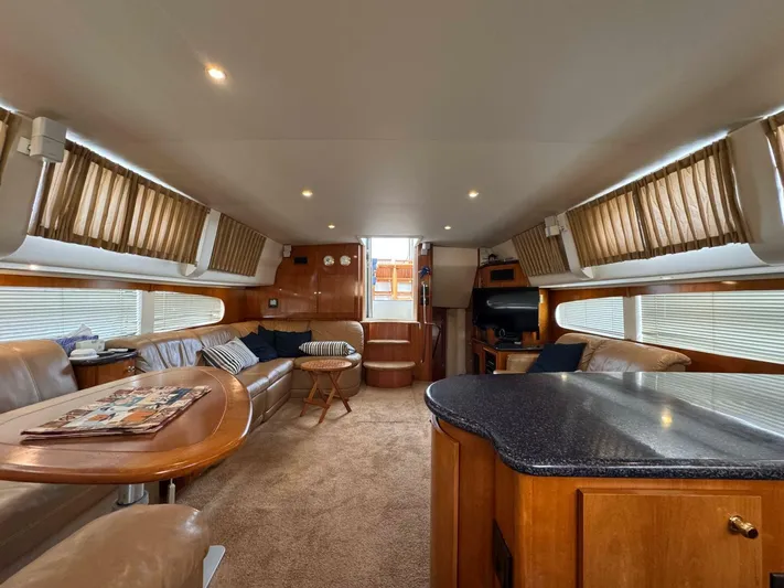  Yacht Photos Pics Luxurious interior of 2002 Carver 466 Motor Yacht with plush seating and elegant wood finishes.