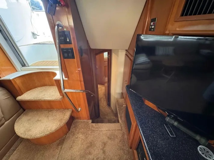  Yacht Photos Pics Interior of 2002 Carver 466 Motor Yacht with stairs and TV.