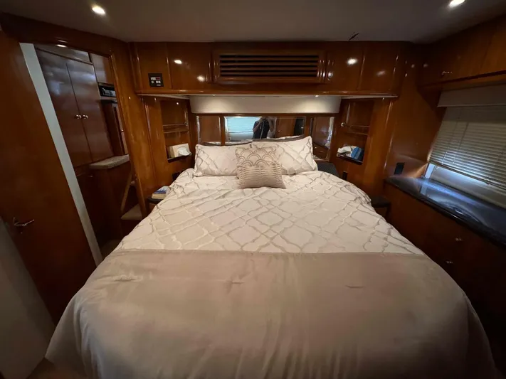  Yacht Photos Pics Luxurious bedroom interior of 2002 Carver 466 Motor Yacht with elegant bedding and wood finishes.