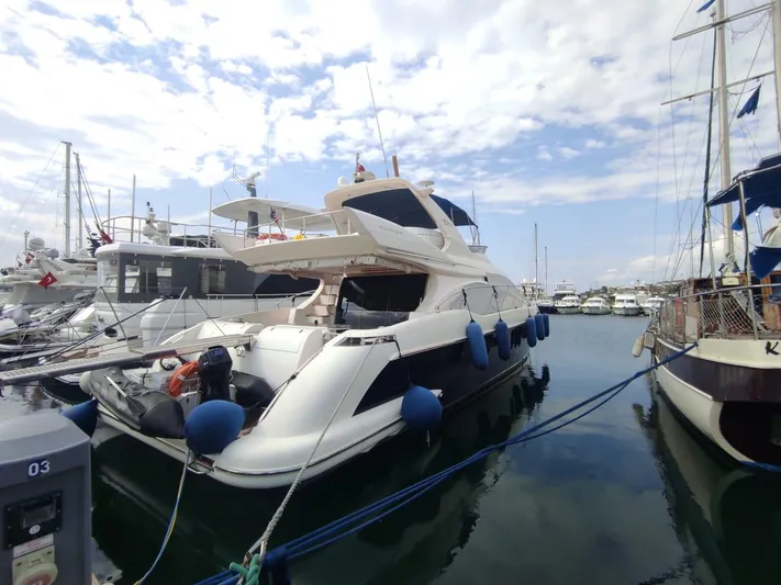  Yacht Photos Pics Luxury 2007 Azimut 62 yacht docked in marina under cloudy sky.