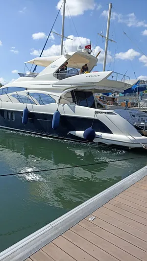  Yacht Photos Pics Luxury 2007 Azimut 62 yacht docked at marina under blue sky.