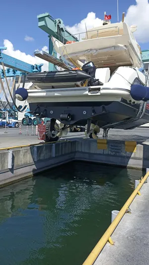  Yacht Photos Pics 2007 Azimut 62 yacht being lifted at a shipyard, ready for maintenance.