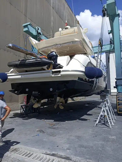  Yacht Photos Pics 2007 Azimut 62 yacht in dry dock for maintenance, with visible lifting equipment.