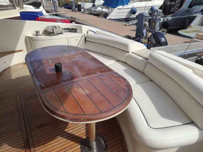  Yacht Photos Pics Luxurious 2007 Azimut 62 yacht with elegant wooden table and white seating on deck.