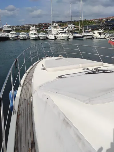  Yacht Photos Pics 2007 Azimut 62 yacht docked in marina, surrounded by other boats under a partly cloudy sky.