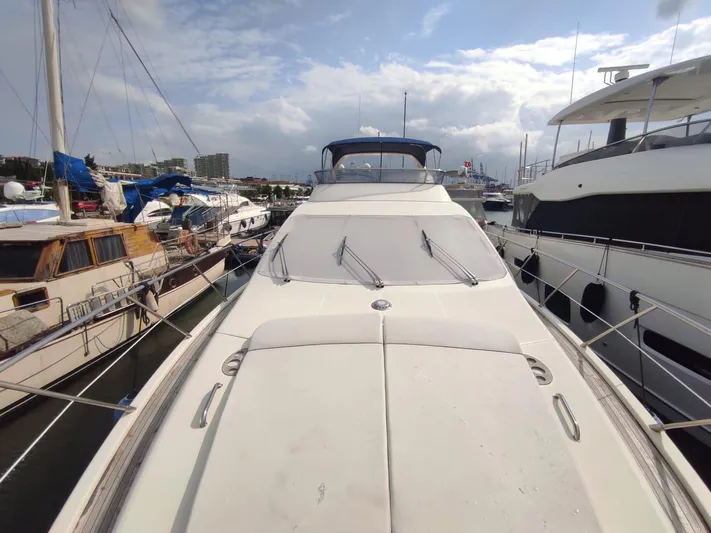  Yacht Photos Pics 2007 Azimut 62 yacht docked at marina under cloudy sky.