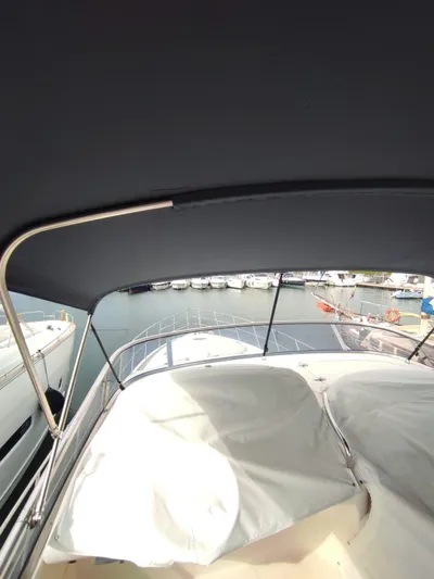  Yacht Photos Pics 2007 Azimut 62 yacht with covered deck, docked at marina.