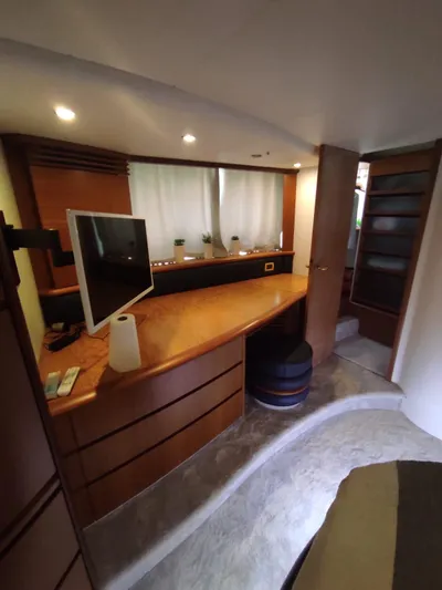  Yacht Photos Pics Interior of a 2007 Azimut 62 yacht with a modern desk and TV setup.