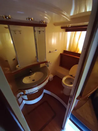  Yacht Photos Pics Luxurious bathroom in 2007 Azimut 62 yacht with elegant fixtures and wooden accents.