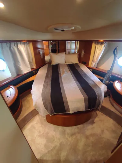  Yacht Photos Pics Luxurious bedroom interior of a 2007 Azimut 62 yacht with a cozy bed.