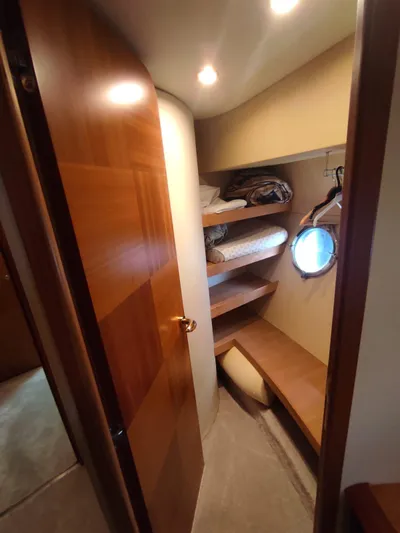  Yacht Photos Pics Interior of 2007 Azimut 62 yacht with wooden shelves and porthole.