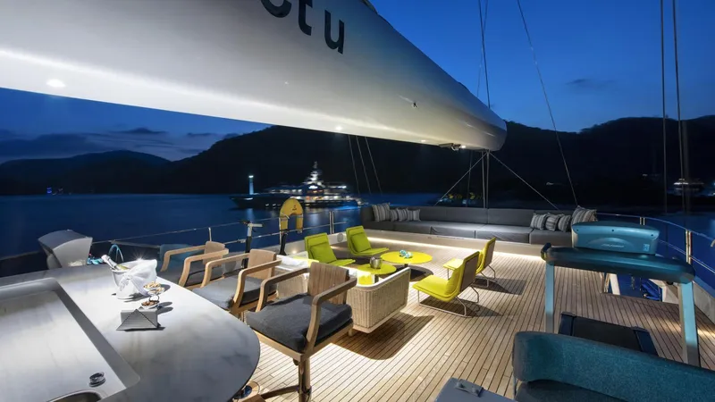 All About U Yacht Photos Pics Luxurious 2018 Ada Yacht sailing deck at dusk, featuring elegant seating and ambient lighting.