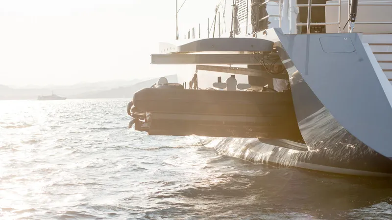 All About U Yacht Photos Pics Ada Yacht 2018 model with tender on water at sunset.