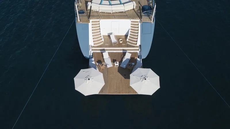 All About U Yacht Photos Pics Aerial view of 2018 Ada Yacht's deck with umbrellas and seating.