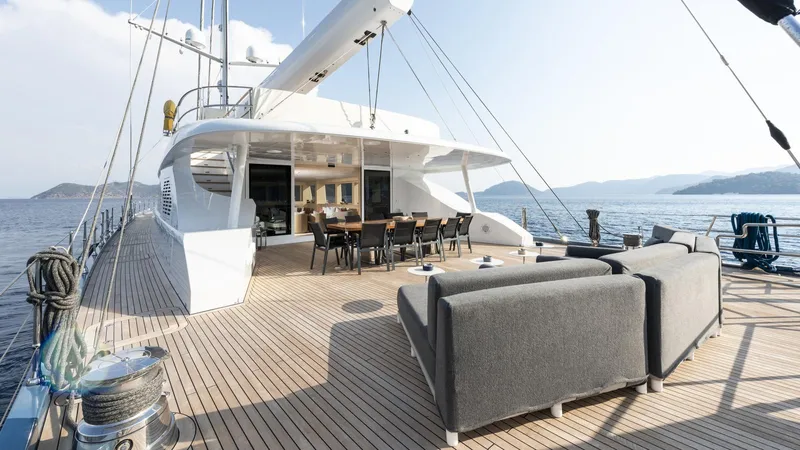 All About U Yacht Photos Pics Luxurious 2018 Ada Yacht sailing deck with seating, dining area, and ocean view.