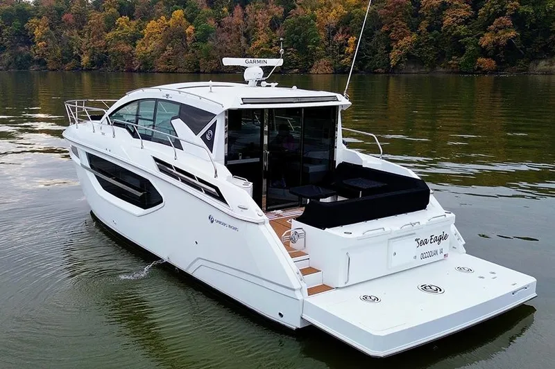  Yacht Photos Pics 2020 Cruisers Yachts 42 Cantius on calm water, surrounded by autumn foliage.