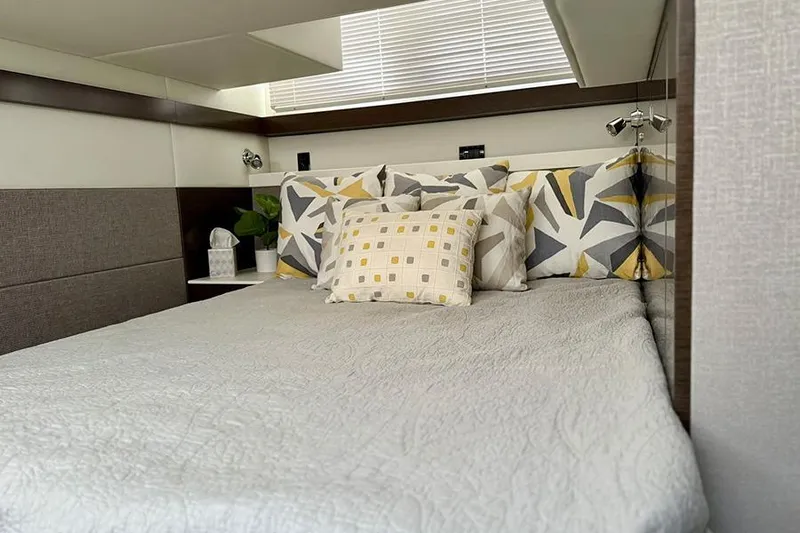  Yacht Photos Pics Luxurious bedroom interior of 2020 Cruisers Yachts 42 Cantius with modern decor and cozy bedding.