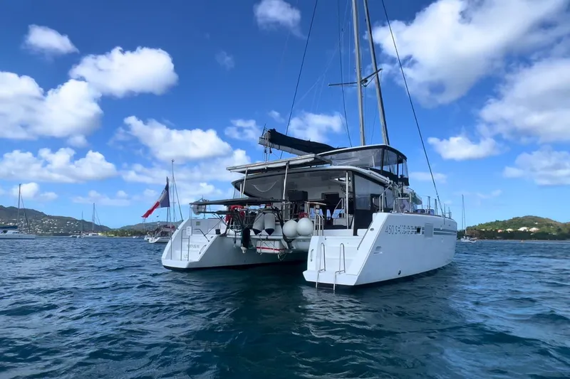 Sixtus Yacht Photos Pics 2016 Lagoon 450 S catamaran on calm waters under a clear blue sky.