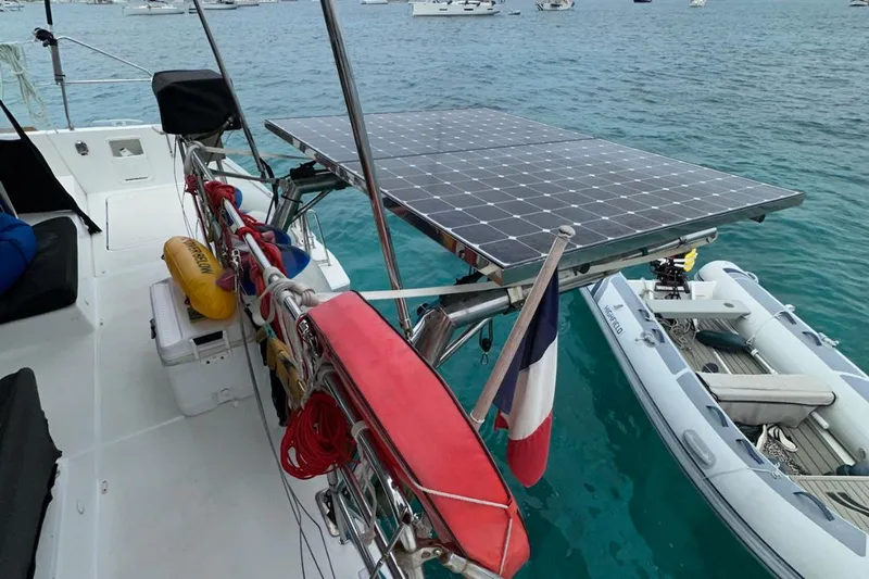 Sixtus Yacht Photos Pics 2016 Lagoon 450 s catamaran with solar panel and dinghy on turquoise water.
