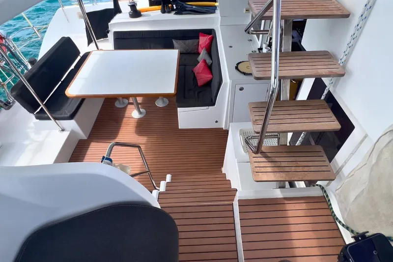 Sixtus Yacht Photos Pics 2016 Lagoon 450 s yacht interior with wooden flooring, seating area, and stairs.
