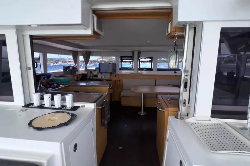 Sixtus Yacht Photos Pics Interior of 2016 Lagoon 450 s catamaran, featuring modern kitchen and dining area with ocean view.