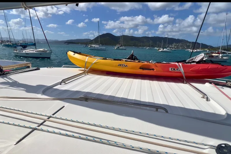 Sixtus Yacht Photos Pics Catamaran Lagoon 450 S with kayaks on deck, anchored in scenic bay, 2016 model.