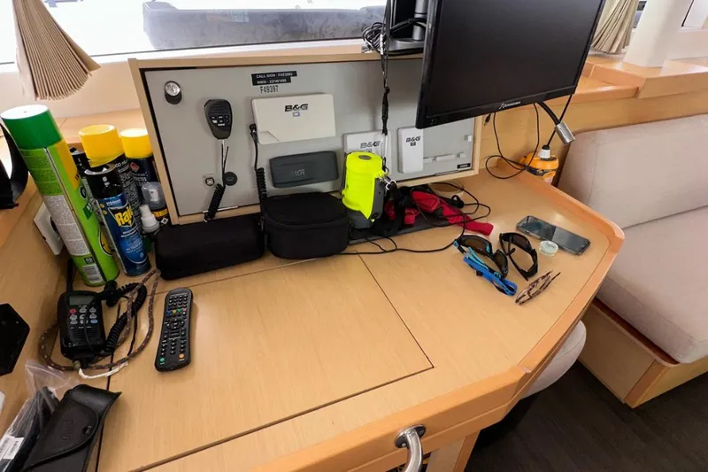 Sixtus Yacht Photos Pics Navigation station on a 2016 Lagoon 450 s catamaran with equipment and supplies.