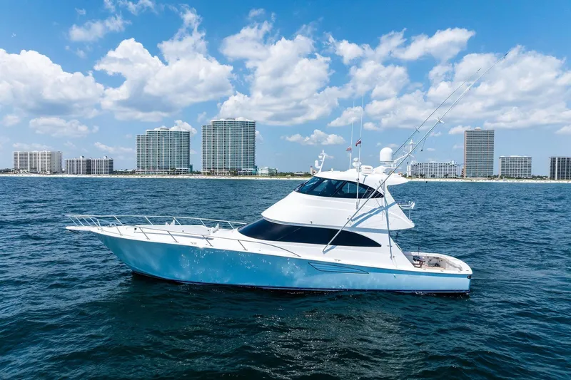 Sexy Lady Yacht Photos Pics 2017 Viking 62 Enclosed Bridge yacht cruising near city skyline on a sunny day.