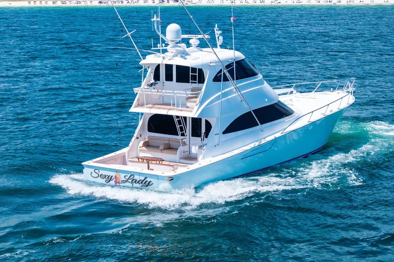 Sexy Lady Yacht Photos Pics 2017 Viking 62 Enclosed Bridge yacht cruising on open water.