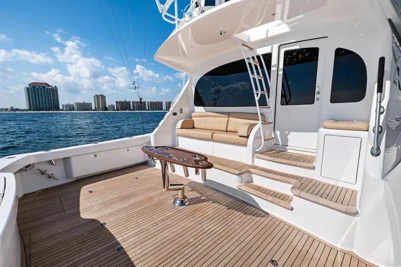 Sexy Lady Yacht Photos Pics 2017 Viking 62 Enclosed Bridge yacht deck with seating, ocean view, and city skyline.