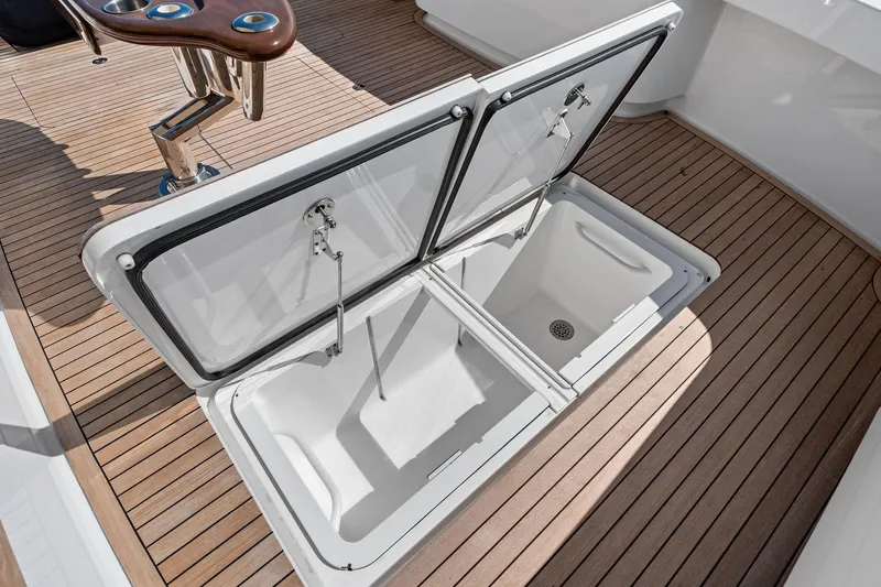 Sexy Lady Yacht Photos Pics Open storage compartment on 2017 Viking 62 Enclosed Bridge yacht deck.