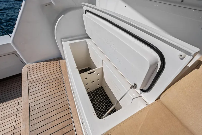 Sexy Lady Yacht Photos Pics Open storage compartment on 2017 Viking 62 Enclosed Bridge yacht with teak flooring.