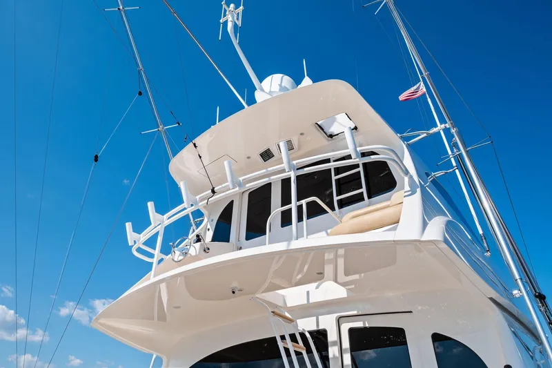Sexy Lady Yacht Photos Pics 2017 Viking 62 Enclosed Bridge yacht against clear blue sky.