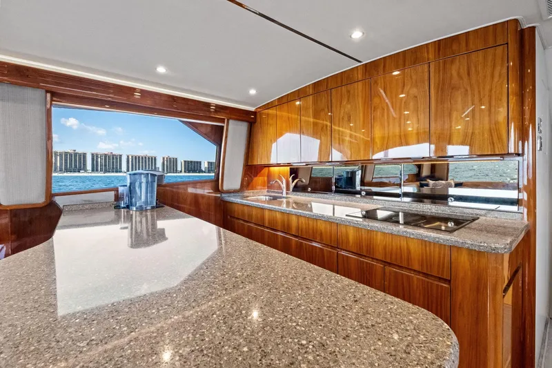 Sexy Lady Yacht Photos Pics Luxurious kitchen interior of 2017 Viking 62 Enclosed Bridge yacht with ocean view.