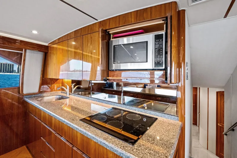 Sexy Lady Yacht Photos Pics Luxurious kitchen interior of 2017 Viking 62 Enclosed Bridge yacht with modern appliances.