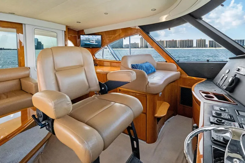 Sexy Lady Yacht Photos Pics Luxurious interior of 2017 Viking 62 Enclosed Bridge yacht with leather seating and ocean view.