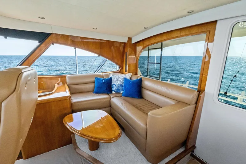 Sexy Lady Yacht Photos Pics Luxurious interior of 2017 Viking 62 Enclosed Bridge yacht with ocean view.