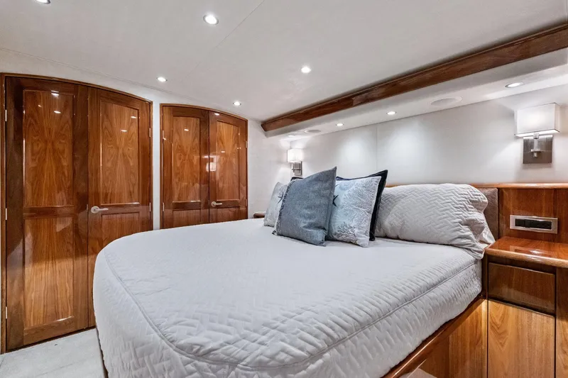 Sexy Lady Yacht Photos Pics Luxurious bedroom interior of 2017 Viking 62 Enclosed Bridge yacht with elegant wood finishes.