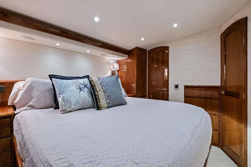 Sexy Lady Yacht Photos Pics Luxurious bedroom interior of 2017 Viking 62 Enclosed Bridge yacht with elegant wood finishes.