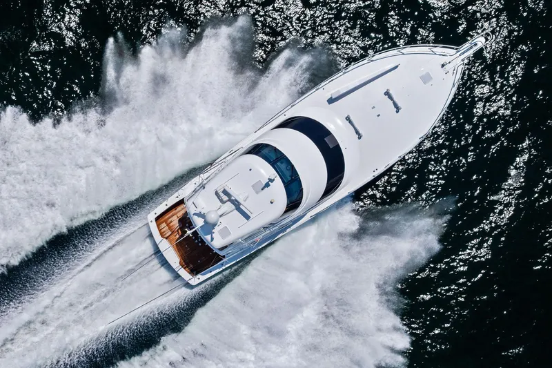 Sexy Lady Yacht Photos Pics Aerial view of 2017 Viking 62 Enclosed Bridge yacht cruising on water.
