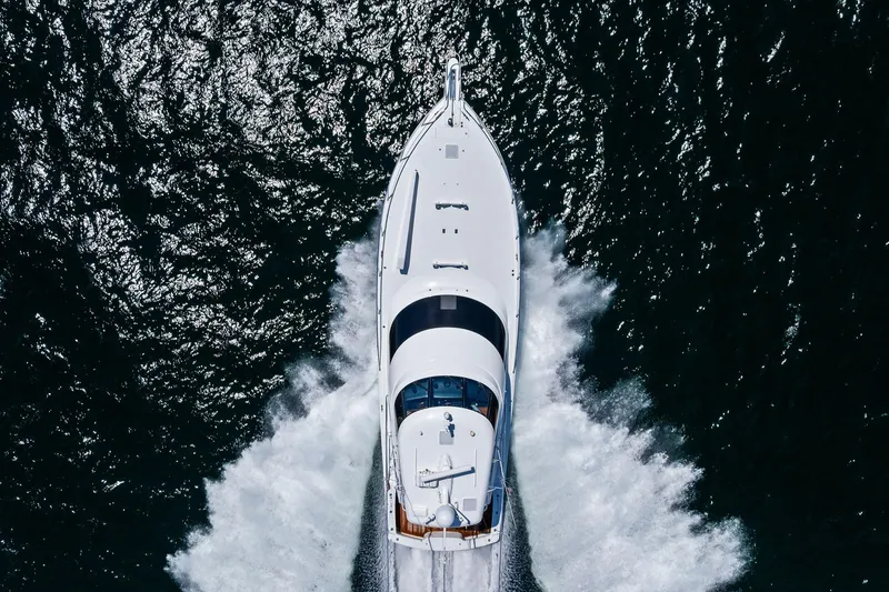 Sexy Lady Yacht Photos Pics Aerial view of 2017 Viking 62 Enclosed Bridge yacht cruising on open water.