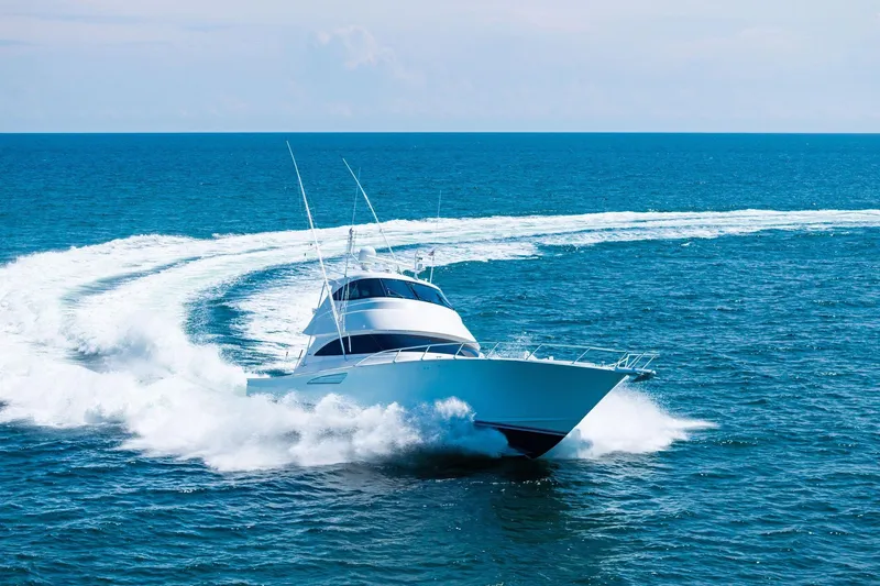 Sexy Lady Yacht Photos Pics 2017 Viking 62 Enclosed Bridge yacht cruising swiftly on open ocean waters.