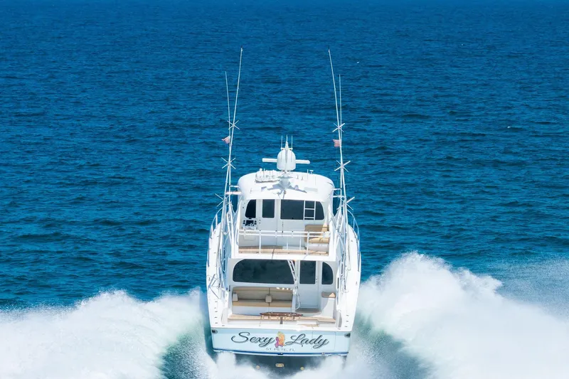 Sexy Lady Yacht Photos Pics 2017 Viking 62 Enclosed Bridge yacht cruising on open ocean waters.