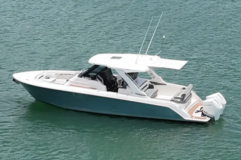  Yacht Photos Pics 2020 Tiara Sport 34 LS boat on calm water, featuring sleek design and modern amenities.