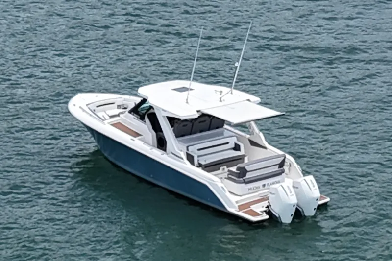  Yacht Photos Pics 2020 Tiara Sport 34 LS boat on water, featuring sleek design and dual engines.