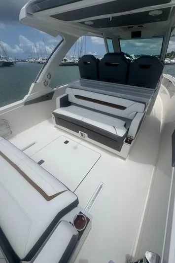  Yacht Photos Pics 2020 Tiara Sport 34 LS boat interior with seating, docked at marina.