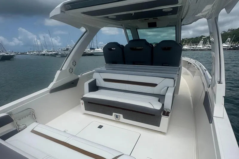  Yacht Photos Pics 2020 Tiara Sport 34 LS boat interior with seating, docked in marina.