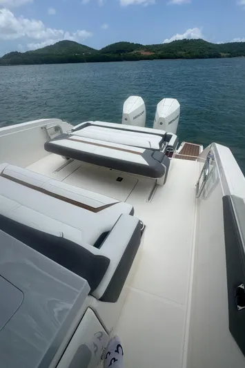  Yacht Photos Pics 2020 Tiara Sport 34 LS boat with dual Mercury engines, scenic water and hills backdrop.