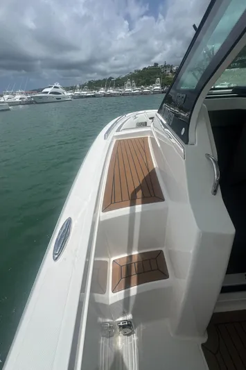  Yacht Photos Pics 2020 Tiara Sport 34 LS boat docked in marina, featuring sleek design and wooden deck.